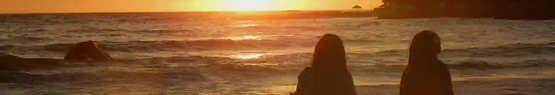 friends at a beach during sunset